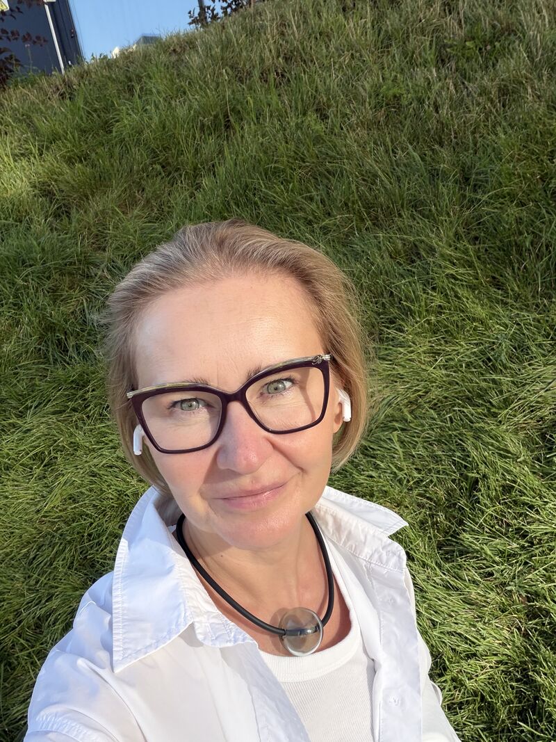 Olga Lavrenova outdoors beside a grassy bank